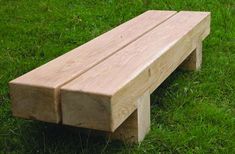 a wooden bench sitting on top of a lush green field