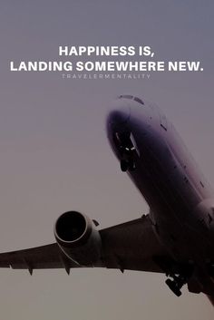 an airplane flying in the sky with a quote on it that says, happiness is landing somewhere new