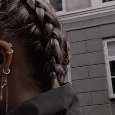 a woman with long hair wearing ear rings