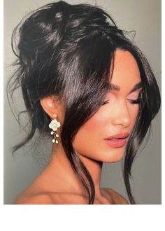 a woman with black hair and white flowers in her hair