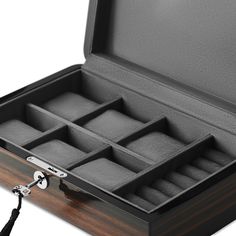 For the dapper gent. Keep your cufflinks right next to your watches and build your style on the fly. A classic watch box to keep your priceless timepieces free of moisture, dust, and impact marks of any kind. Made of dense fibreboard and finished with stunning glossy ebony veneer. The lid features robust quadrant hinges, and the inside is lined with high-quality grey velvet. Stands on 4 metal legs. Stores 6 watches. Designed in Denmark. Classic Rectangular Case Watches For Formal Occasions, Classic Formal Watch With Rectangular Case, Classic Formal Watches With Rectangular Case, Classic Formal Watch Accessories With Gift Box, Classic Box-shaped Watch Accessories For Business, Classic Business Watch Accessories Box, Classic Formal Box Watch Accessories, Classic Rectangular Business Watch Case, Classic Rectangular Watch Case For Business