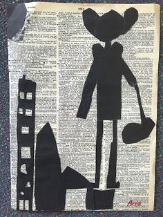 a piece of paper cut out of the shape of a person holding a bucket and shovel