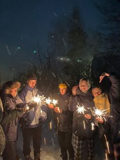 a group of people holding sparklers in their hands