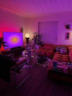 a living room filled with furniture and a flat screen tv