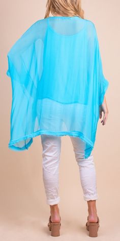 2 Piece High-Low Silk Kaftan Featuring a Raw Edge Bottom Hemline. Exterior 100% Silk Interior 95% Viscose, 5% Elastic One Sizes Fits Most Made in Italy Model 5'7 One Size Summer Beach Blouse, Lightweight Solid Color Summer Tops, Stretch Solid Color Blouse For The Beach, Lightweight Solid Tops For Summer, Spring Beach Cover-up Top, Spring Solid Color Stretch Cover-up, Spring Solid Stretch Cover-up, Spring Stretch Solid Color Cover-up, Blue V-neck Top