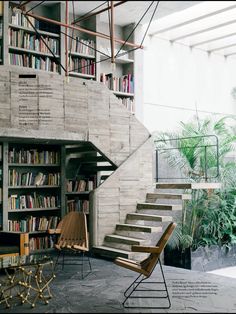 the stairs are made of concrete and have bookshelves