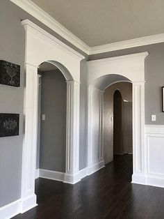 an empty room with wood floors and white trim