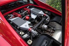 the engine compartment of a red sports car