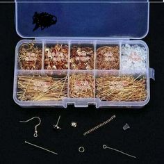 an open plastic box filled with lots of different types of pins and needles in it