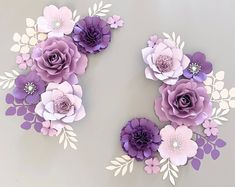 paper flowers are arranged in the shape of letters s and v on a gray background