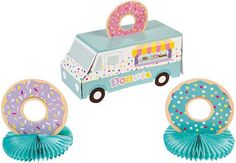 two doughnuts are in front of an ice cream truck with donuts on it