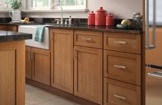 a kitchen with wooden cabinets and black counter tops