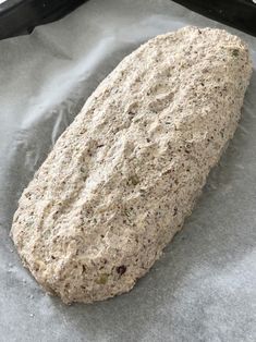 a loaf of bread sitting on top of a piece of wax paper