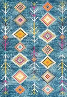 a blue area rug with an arrow design on it and multicolored diamonds in the middle