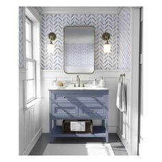 a bathroom with a blue vanity and white wallpaper on the walls next to a mirror