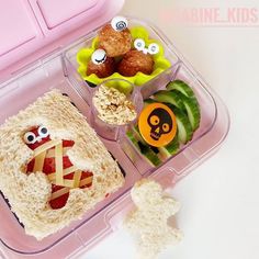 a pink lunch box filled with lots of food