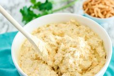 a white bowl filled with mashed potato salad