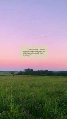 the sky is pink and purple as the sun sets over an open field with tall grass