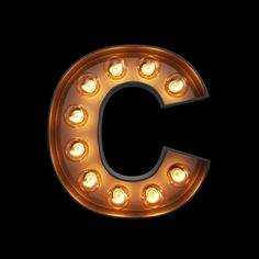 the letter c is made up of light bulbs and has an uppercase g in it