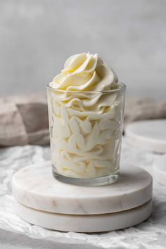 cream cheese frosting without butter in a glass cup on a marble stand with text overlay