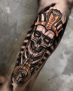 a man with a tattoo on his arm that has an image of a skull in the middle