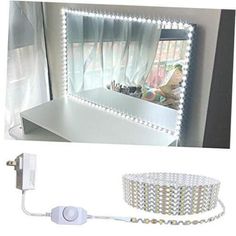 an image of a mirror with lights on it and a cord attached to the wall