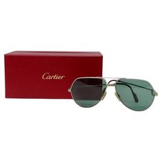 Cartier aviator style sunglasses featuring Cartier's signature titanium screw motif circa 1980s. Thin silver frames with solid yellow gold screws are complimented by tinted UV protectant lenses. Ear paddles feature red enamel with gold Cartier signatures. These sunglasses are such are a versatile and essential piece for any Cartier collector as they will match with all of your jewelry and are suitable for any occasion. Pair these with a silver Louis Vuitton necklace and some Cartier love bracele Silver Louis Vuitton, Louis Vuitton Necklace, Cartier Sunglasses, Cartier Santos, Cartier Jewelry, Style Sunglasses, Silver Frames, Aviator Style, Cartier Love