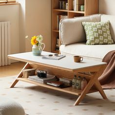 a living room with a couch, coffee table and bookshelf