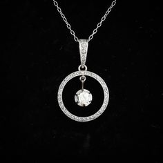 An antique Edwardian diamond circle pendant, set in 18ct gold and platinum. It is set with an old mine cut diamond to the centre, on a knife edge setting which moves, and is surrounded by 42 rose cut diamonds, including the diamond set bail. It is completely handmade and is a fine example of the craftsmanship of the era. The central diamond weighs approx 0.23ct, and is K/L in colour,. SI1/SI2 clarity. Diamond: Old Mine Cut, Colour K/L, clarity SI1/SI2, length 3.98mm, width 3.88mm, depth 2.20mm. Sterling Silver Round Diamond Necklace With Rose Cut Diamonds, Sterling Silver Diamond Necklace With Rose Cut Diamonds, Classic Round Diamond Necklace With Rose Cut Diamonds, Diamond White Necklace With Rose Cut Diamonds, Timeless Hallmarked Round Diamond Necklace, White Gold Rose Cut Round Diamond Necklace, White Gold Round Rose Cut Diamond Necklace, White Gold Diamond Necklace With Rose Cut Diamonds, Round Rose Cut Diamond Necklace