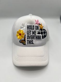 White "Hold on let me overthink this" Trucker hat with flowers, butterflies, starts and heart embroidered patch. Cheap Customizable White Trucker Hat, White Trucker Baseball Cap With Embroidered Patch, White Patches Hat For Summer, Adjustable White Hat With Patches, White Patches Trucker Hat, Casual White Baseball Cap With Patches, White Trucker Hat With Embroidered Patch, Spring Trucker Hat With Patches, Trendy White Trucker Hat With Letter Print