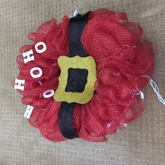 a red and black mesh wreath with the word hooh written in white on it