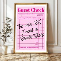 a pink poster with the words guest check on it next to a potted plant