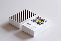 two business cards with qr code on them sitting next to each other in front of a white background