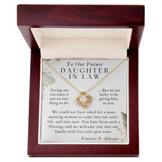 a necklace in a wooden box with an i love you message