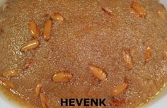 there is a brown cake with nuts in it on the plate and words hevenk above it