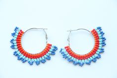 These hoop earrings are made using traditional freehand beading techniques. Earrings are made of quality Czech beads and strong thread. Stainless steel hoops. Earrings are 4.5 cm ( 1.8 inches)  length and 5 cm ( 2 inches) width. Colors: orange,red,blue. 100% handmade. Don't forget to check out my other hoop earrings in the store. Maybe you will find exactly what you are looking for. https://www.etsy.com/shop/SandasHandmades The photo may not convey true colors. This may depend on the settings of Gift Dangle Hoop Earrings With Spacer Beads, Festive Beaded Hoop Earrings With Round Beads, Festive Beaded Hoop Earrings, Handmade Hoop Earrings For Festive Occasions, Handmade Beaded Hoop Earrings Gift, Handmade Beaded Hoop Earrings For Gifts, Handmade Dangle Hoop Earrings For Festive Occasions, Traditional Handmade Hoop Beaded Earrings, Traditional Beaded Hoop Earrings As Gift