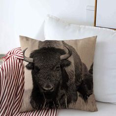 a pillow with an image of a buffalo on it and a red striped throw pillow