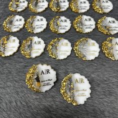 some white and gold buttons on a fur surface with the word air written in it