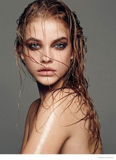 a woman with wet hair and blue eyes posing for a magazine cover photo by photographer