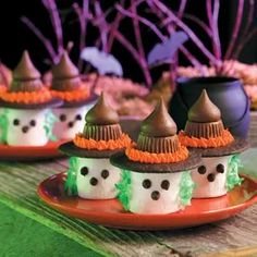 small cupcakes decorated with chocolate and candy on a plate in the shape of witches