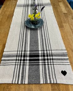 a plaid table runner with yellow flowers on it