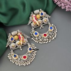 Oxidized silver pachi kundan drop earring with beautiful carving, peacock motif  and pearl details. Inspire your style with latest fancy German silver earring in  Ruby, white and Ruby white combination.                       Best quality of craftsmanship with premium ahemdabadi pachi kundan.                  All orders Ship same day if placed before 4:00 PM EST  Create beautiful memory for any occasion with elegant jewelry for your loved ones You will receive carefully packaged items in jewelry Peacock Motif, German Silver Jewelry, Peacock Earrings, Antique Jewellery Designs, Fancy Jewellery Designs, Silver Statement Earrings, Pearl Details, Earring Silver, Statement Earring