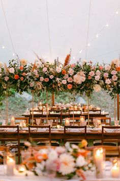 the tables are set up with candles and flowers on them for an outdoor wedding reception