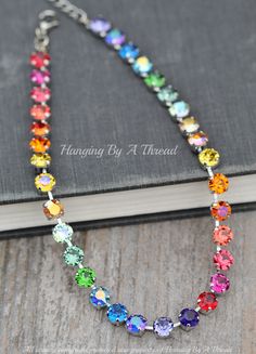 "A lovely new necklace made entirely with swarovski crystal. The necklace features 8mm crystals in varying bright, jewel toned colors. All are hand set into a premium necklace setting. Shown in silver in all images above, but also can be made in gold, rose gold, or antique brass. Necklace closes with a lobster clasp and will adjust from 15-20\" long. Please choose desired metal finish at checkout. * Nickel and lead free ** All crystal pieces should be treated with care. Being higher end costume jewelry, please do not shower, bathe, work out in, or expose to chemicals like perfumes and hair spray. store in a cool dry place away from moisture." Dark Rainbow, Rainbow Ombre, Jewel Tone Colors, Necklace Swarovski, Rhinestone Choker, Tennis Necklace, Brass Necklace, Lgbtq Pride, Jewel Tones