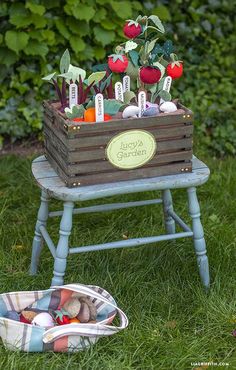 a wooden crate filled with vegetables sitting on top of a grass covered field next to a basket