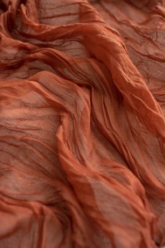 an orange cloth is laying on top of a white surface and it looks like something out of space