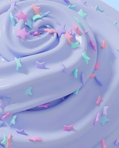 a close up view of a frosted cake with stars on it's icing