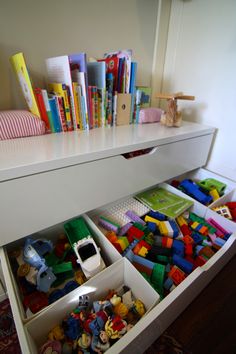 the drawers are filled with toys and books