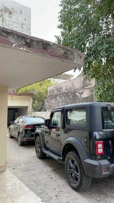 two cars parked next to each other in front of a building