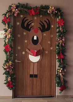 the door is decorated with christmas decorations and paper cutouts, including a reindeer holding a book